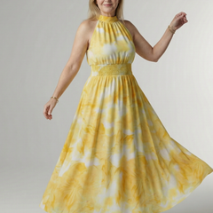 Yellow gathered halter midi dress with smocked waist and flowing tiered skirt