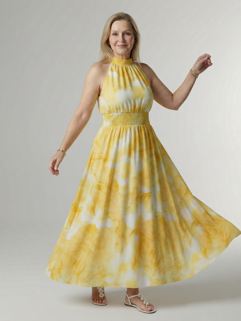 Yellow gathered halter midi dress with smocked waist and flowing tiered skirt