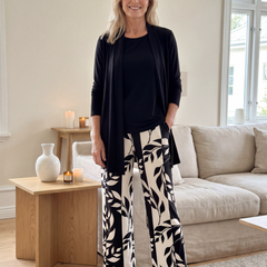 Black three-piece casual set: cardigan, scoop-neck top, leaf-print wide-leg pants