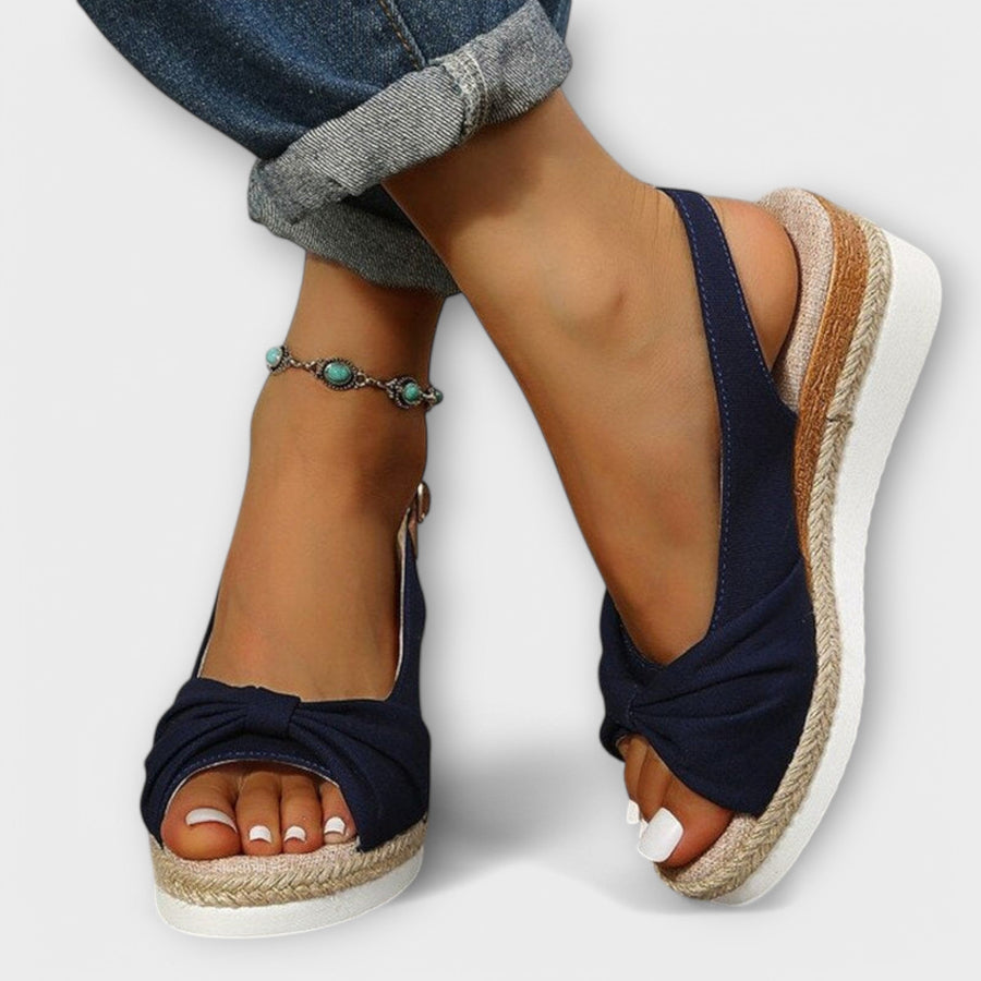 Navy espadrille sandals with bow-tied front and jute wedge sole