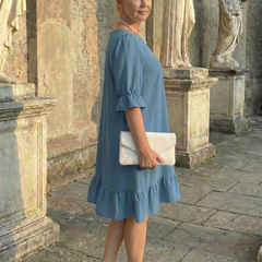 Blue ruffle day dress with tiered hem and elbow-length puff sleeves