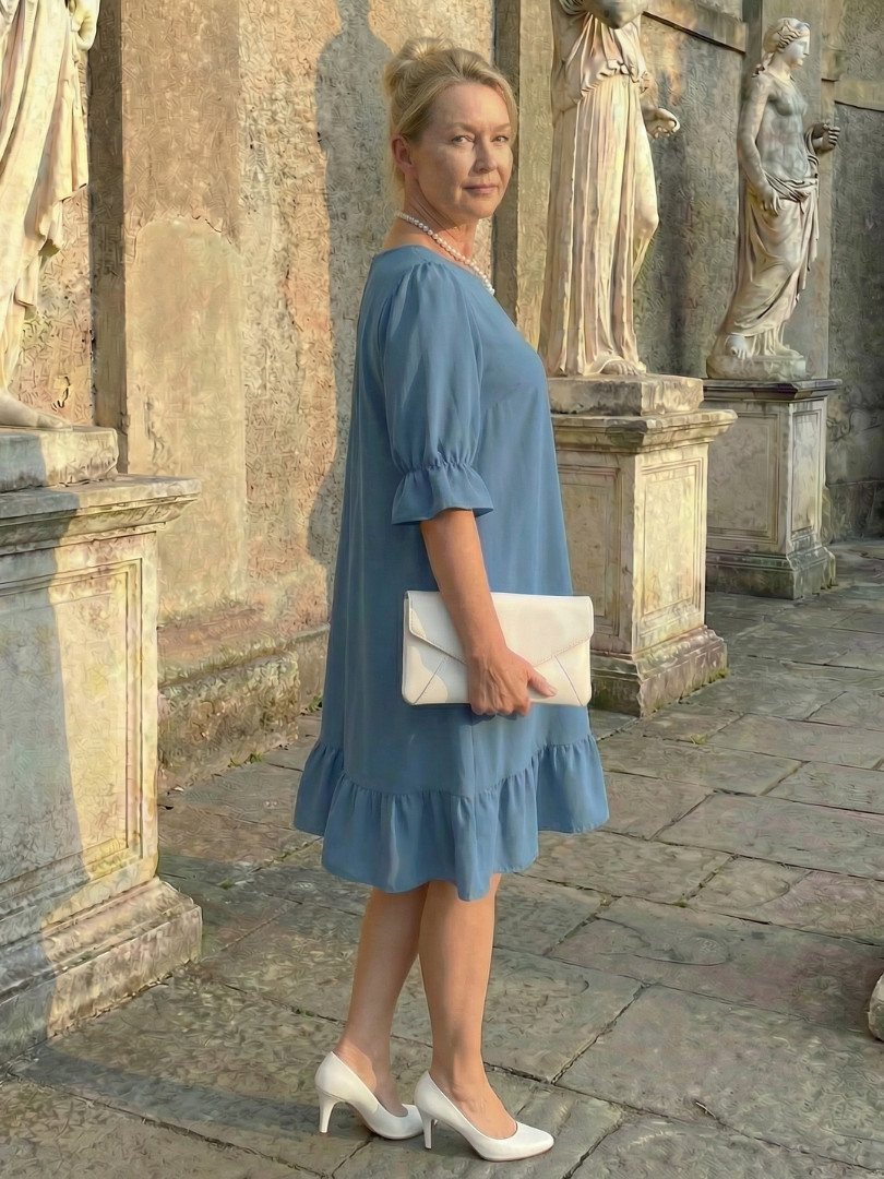 Blue ruffle day dress with tiered hem and elbow-length puff sleeves