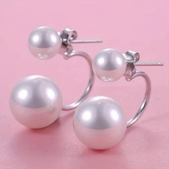 Large double-pearl statement earrings with glossy white spheres on silver hoops