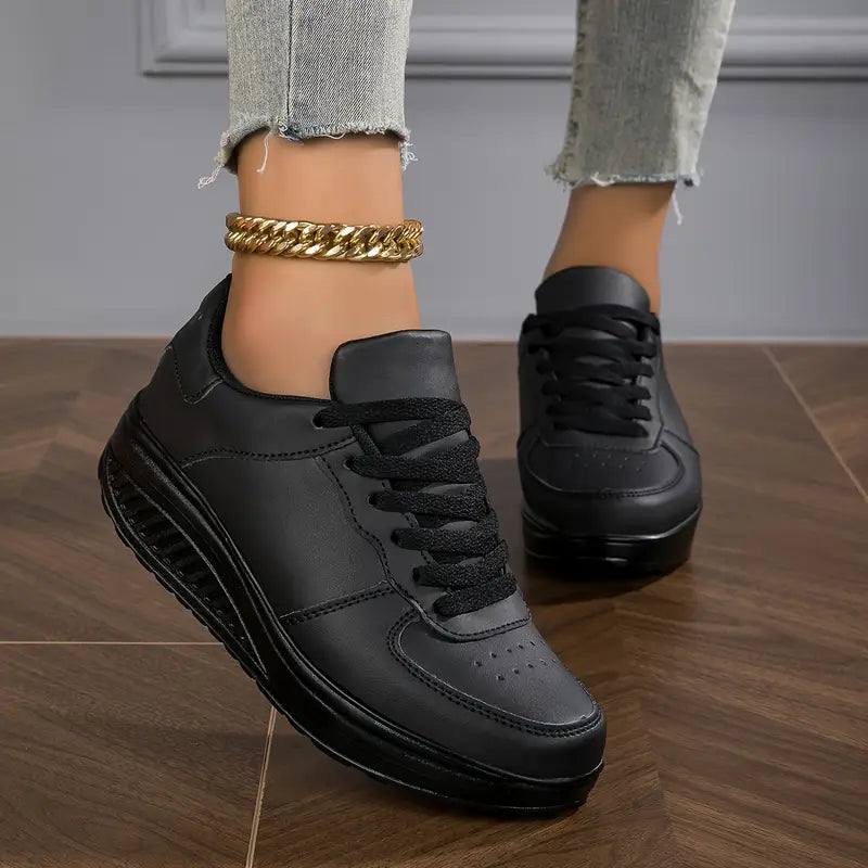 Black platform comfort sneakers with white midsole edge and lace-up design