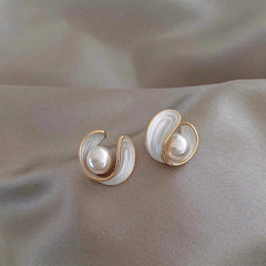 Gold-tone pearl stud earrings with teardrop metal frames and white pearls