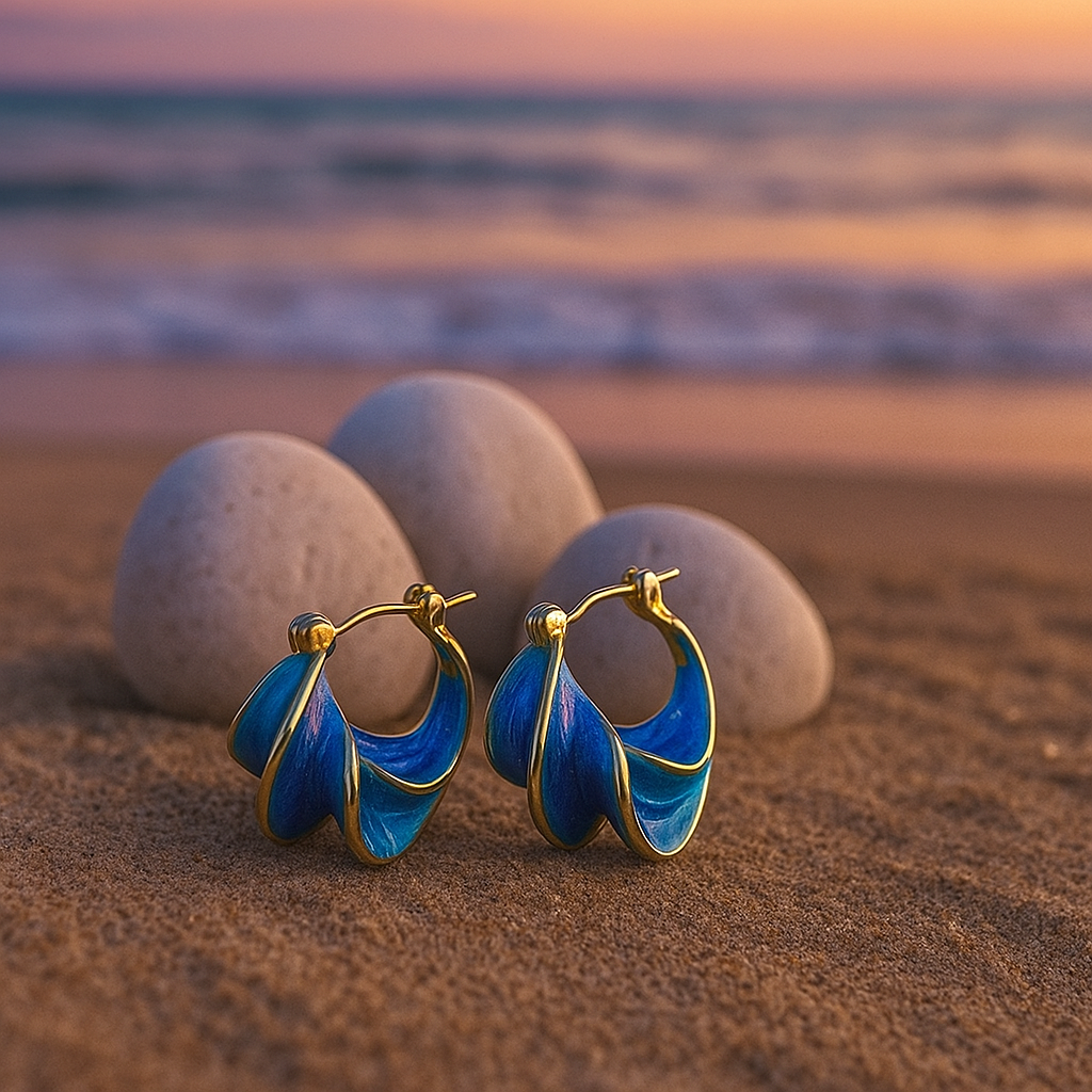 Gold hoop earrings with blue wave enamel, front view showing rounded open hoops