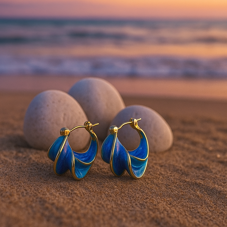 Gold hoop earrings with blue wave enamel, front view showing rounded open hoops
