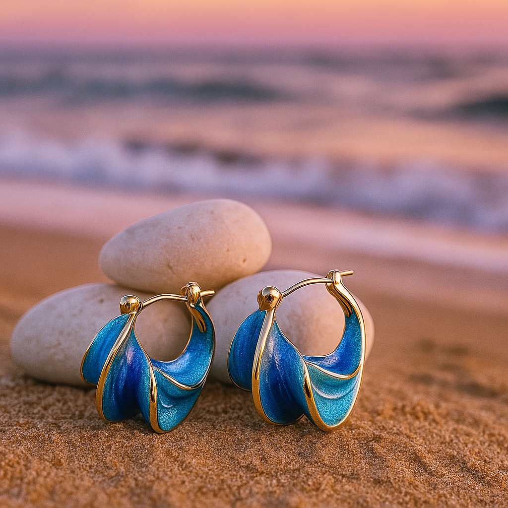 Gold hoop earrings with blue wave enamel, small teardrop loops on hinged clasps