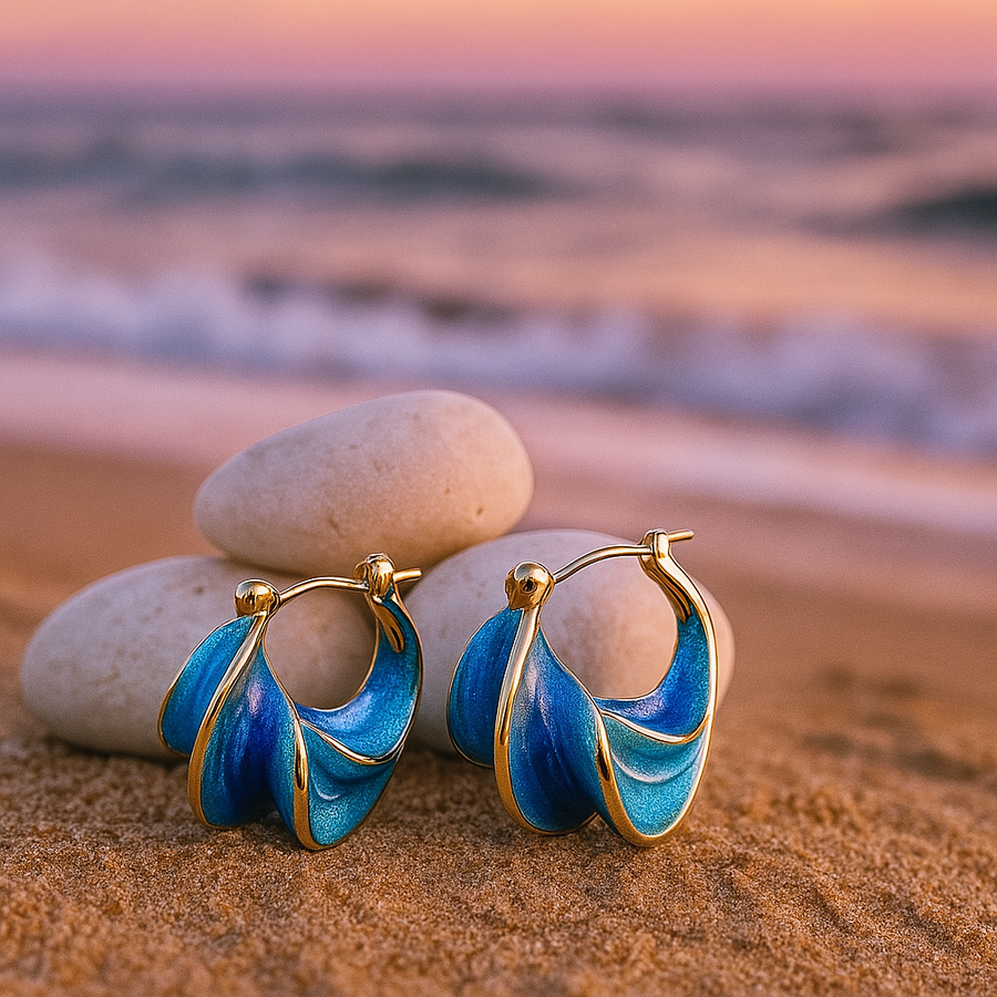 Gold hoop earrings with blue wave enamel, small teardrop loops on hinged clasps