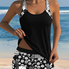 Belly-covering swim set with black tank top and black-and-white floral patterned swim shorts