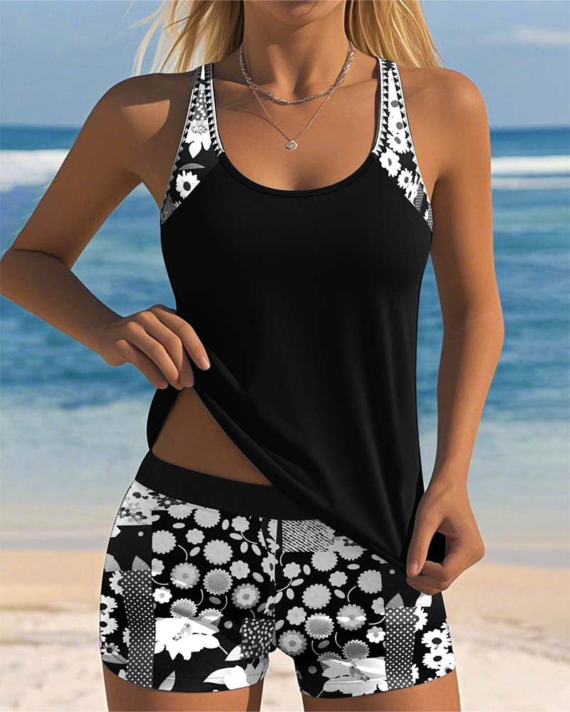 Black two-piece swimwear set with patterned shorts; scoop-neck tank with contrast straps.