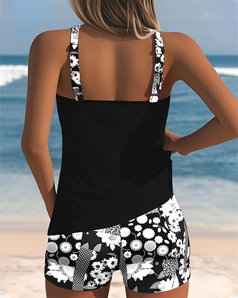 Belly-covering swim set, black racerback tank and black-and-white floral patterned swim shorts, back view