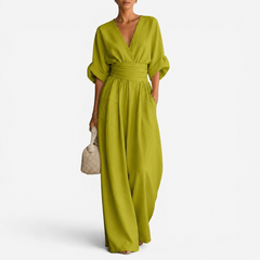 Lime green V-neck jumpsuit with gathered waist and wide-leg drape.