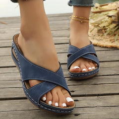 Blue open-toe sandals with cross straps and stitched platform sole