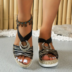 Black platform espadrille sandals with zebra print straps and silver ring buckles