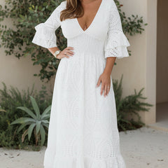 Waist-sculpting white maxi dress with V-neck, flutter sleeves, and eyelet tiered skirt