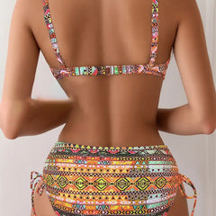 Printed bikini set back view: strappy bralette with clasp and ruched high-cut bottoms with ties.