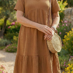 Brown woven ease dress close-up of V-neck and tiered bodice and skirt