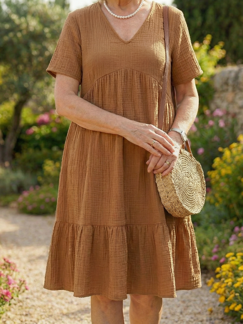 Brown woven ease dress close-up of V-neck and tiered bodice and skirt