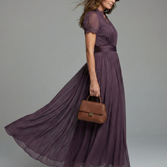 Purple maxi dress with gathered waist, puff sleeves, and flowing pleated skirt