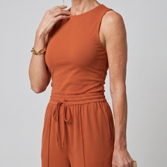 Rust-orange sleeveless top and matching wide-leg pants with elastic drawstring waist