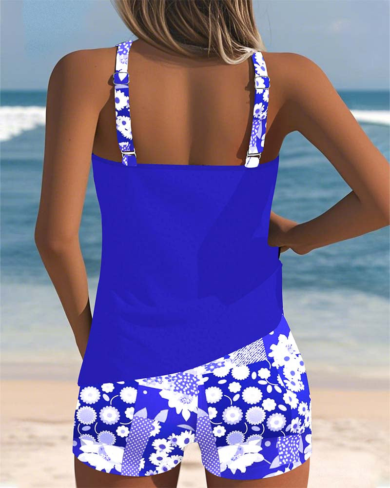 Back view of royal blue two-piece swimwear set: open-back tank with patterned swim shorts.