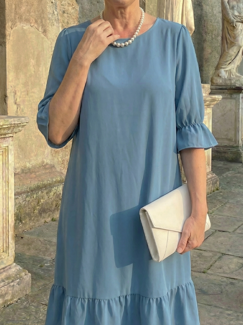Blue ruffle day dress with gathered neckline and tiered ruffle hem