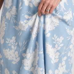Close-up of light blue floral fabric with V-neck bodice and gathered skirt detail
