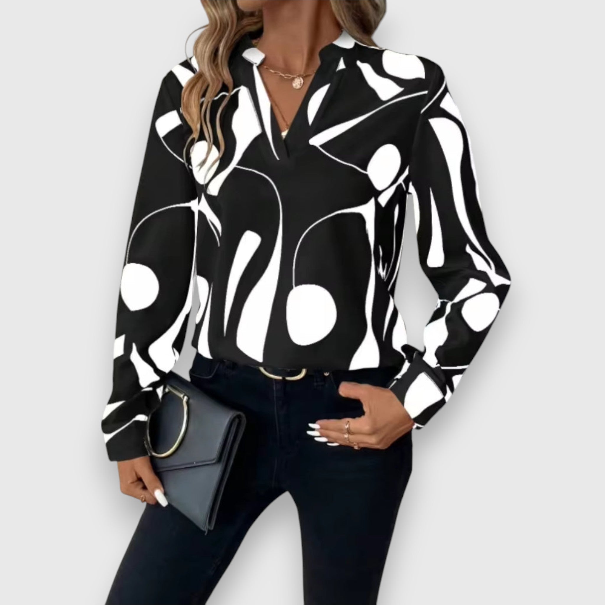Black long-sleeve V-neck blouse with bold white abstract pattern
