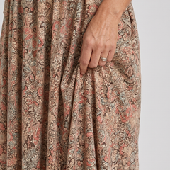 Floral midi dress close-up showing pleated bodice and full gathered skirt