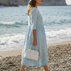 Sky blue garden-print midi dress with gold leaf pattern, three-quarter sleeves, tiered skirt