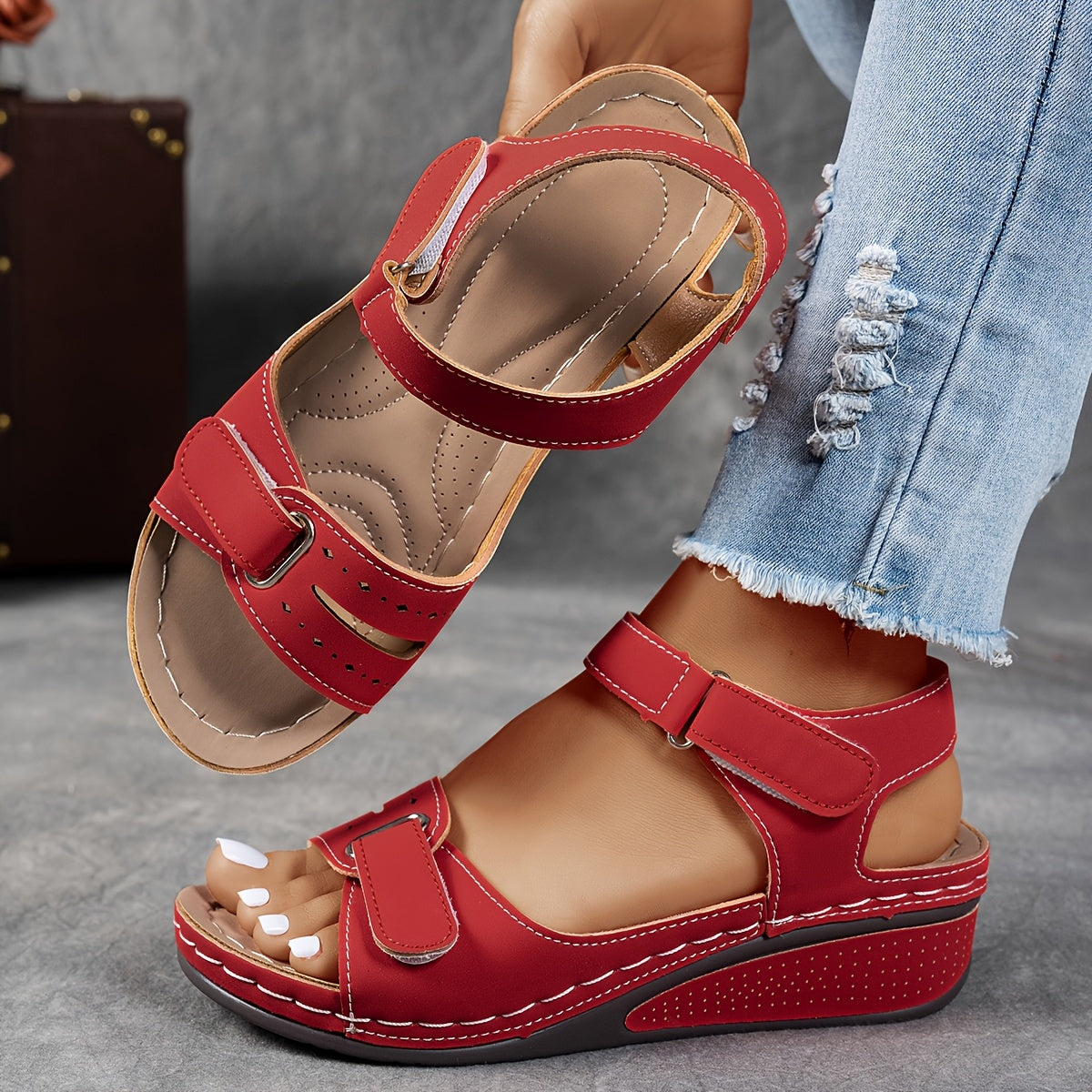 Red leather open-toe sandals with two hook-and-loop straps and cushioned footbed