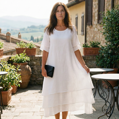 White tiered midi dress with short sleeves and layered asymmetrical hem