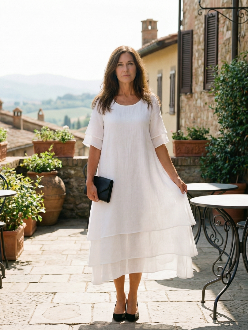 White tiered midi dress with short sleeves and layered asymmetrical hem