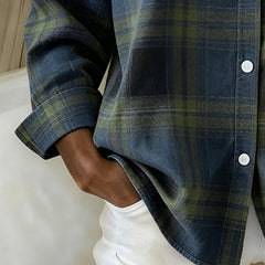 Plaid shirt sleeve detail in dark blue with green lines, button-up front