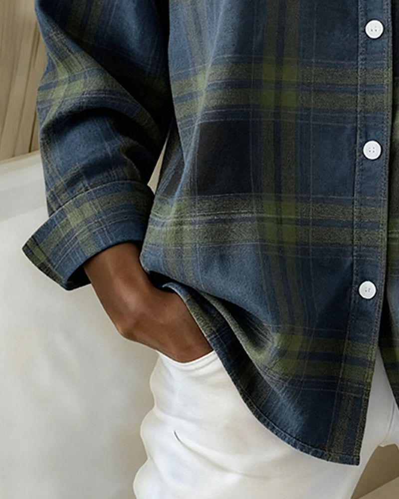 Plaid shirt sleeve detail in dark blue with green lines, button-up front