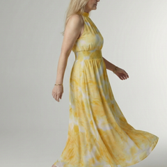 Yellow gathered halter midi dress, side view, smocked waist and full swing skirt