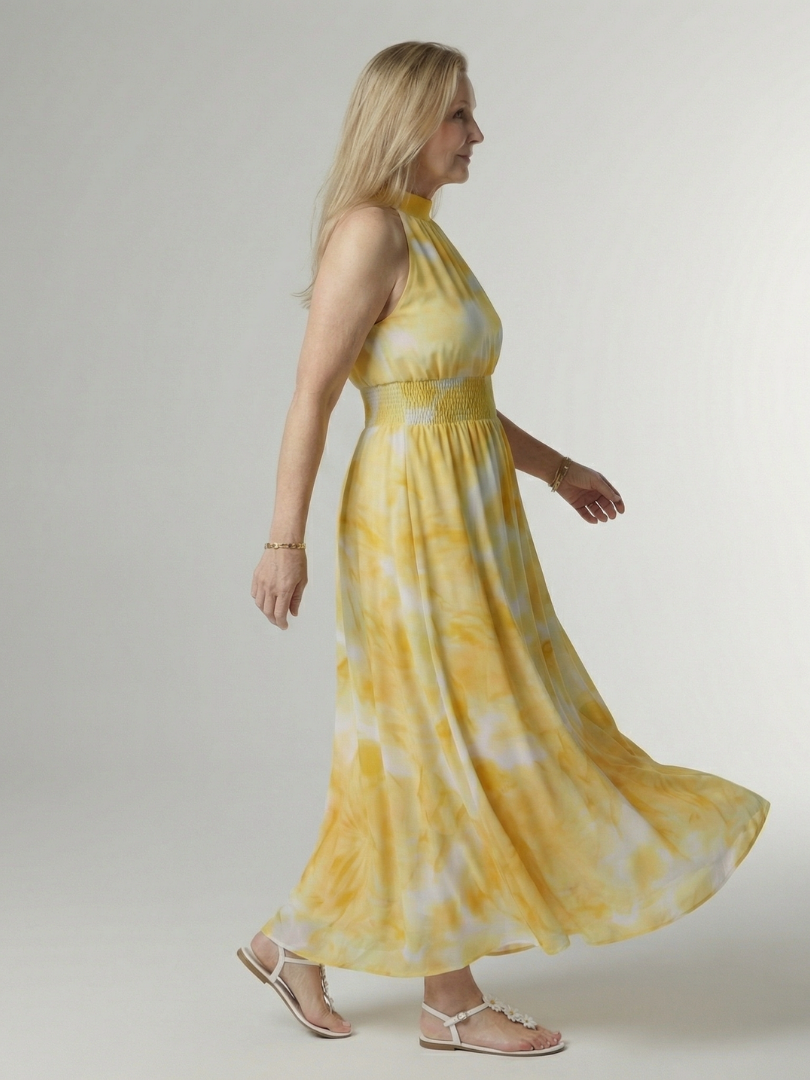 Yellow gathered halter midi dress, side view, smocked waist and full swing skirt