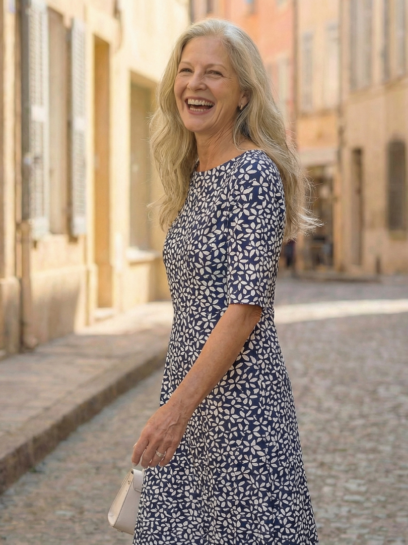 Blue patterned midi dress, short sleeves and round neckline, side view