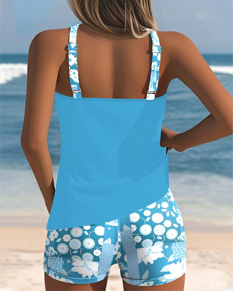 Belly-covering swim set, light blue racerback tank and blue floral patterned swim shorts, back view