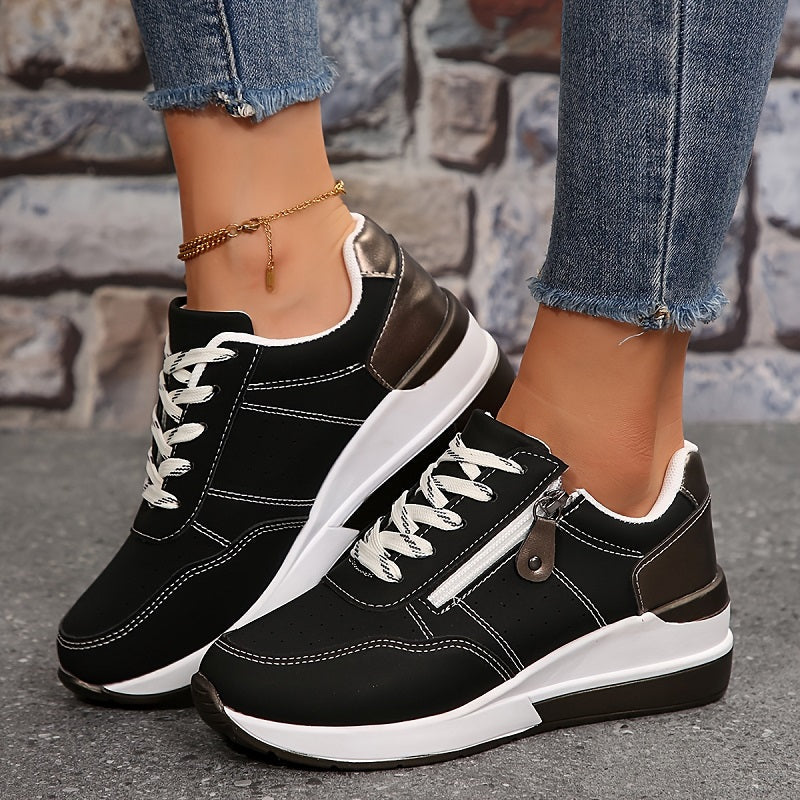Black zip-up sneakers with lace-up front, side zipper, white sole and chunky rubber heel