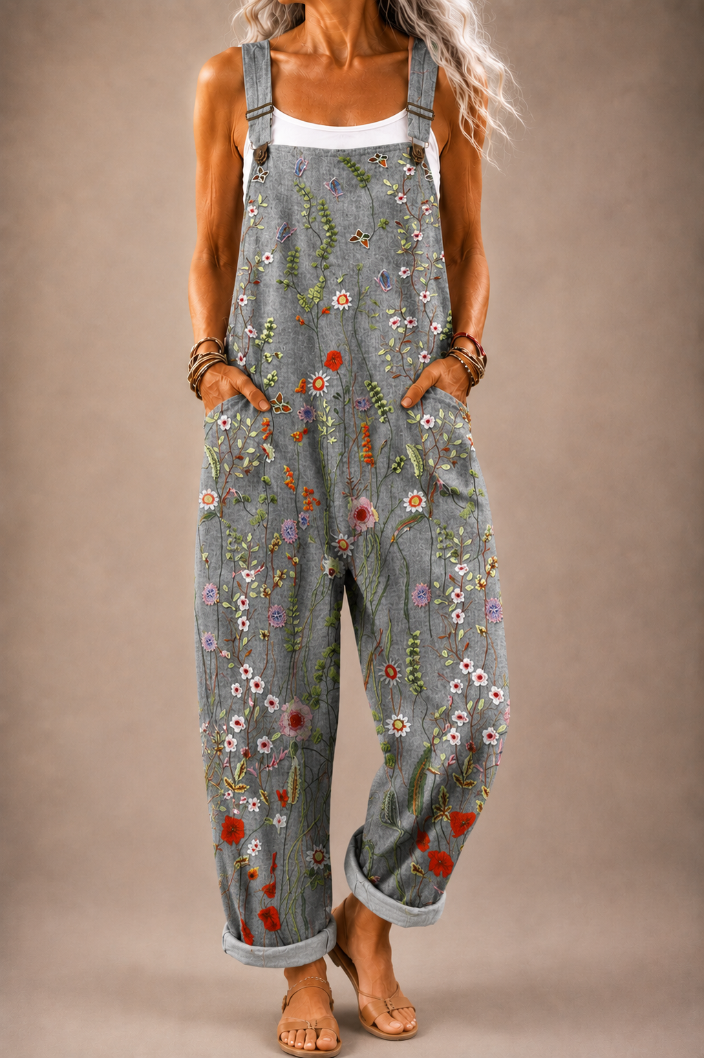 Grey floral-print denim-style overalls with adjustable straps and front bib pocket