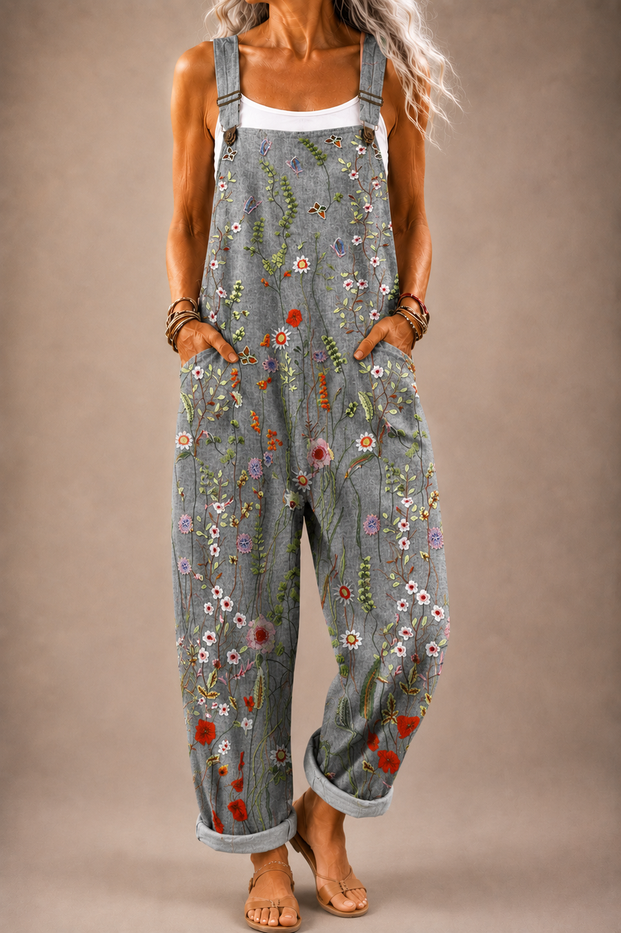 Grey floral-print denim-style overalls with adjustable straps and front bib pocket