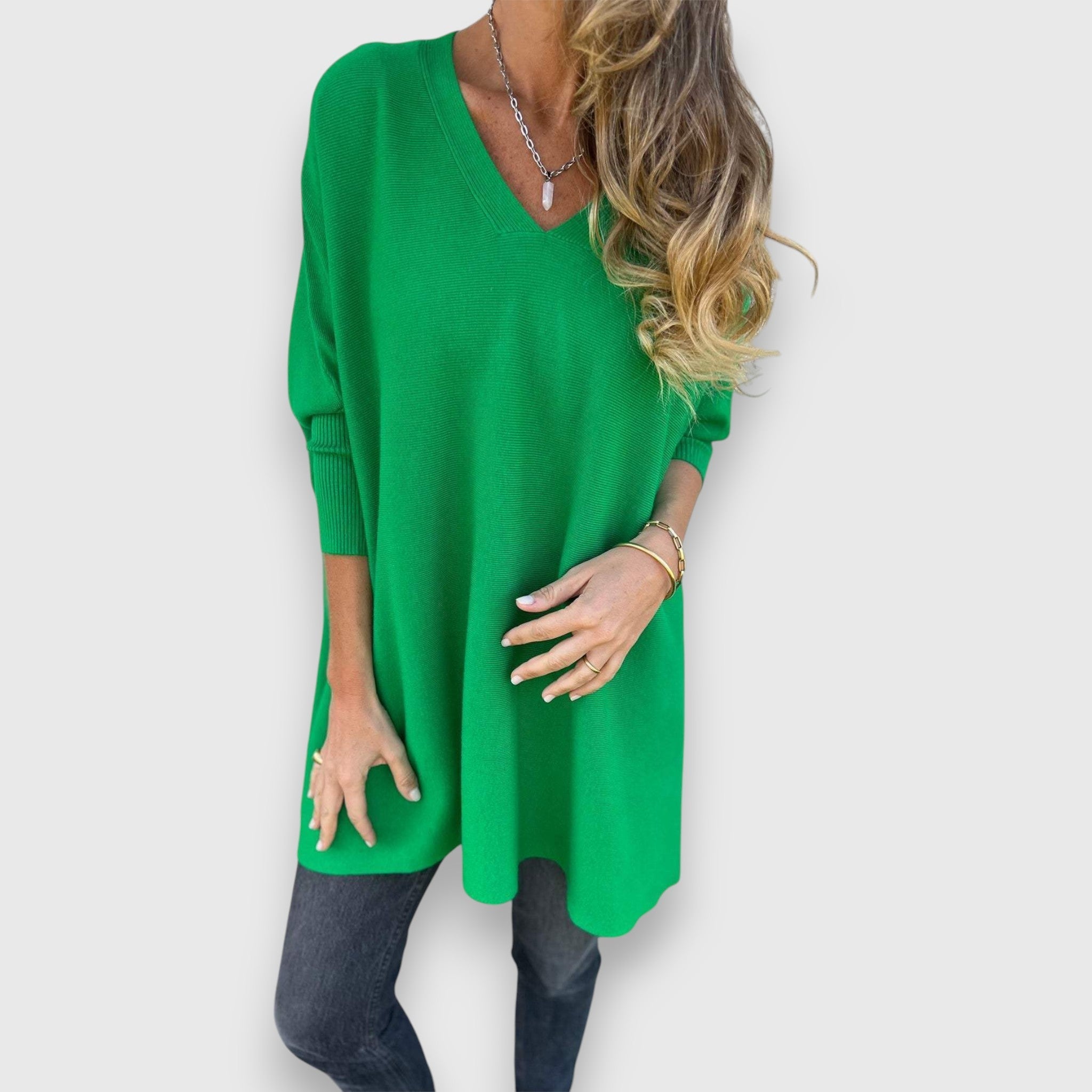 Green oversized V-neck sweater with loose knit and long sleeves.