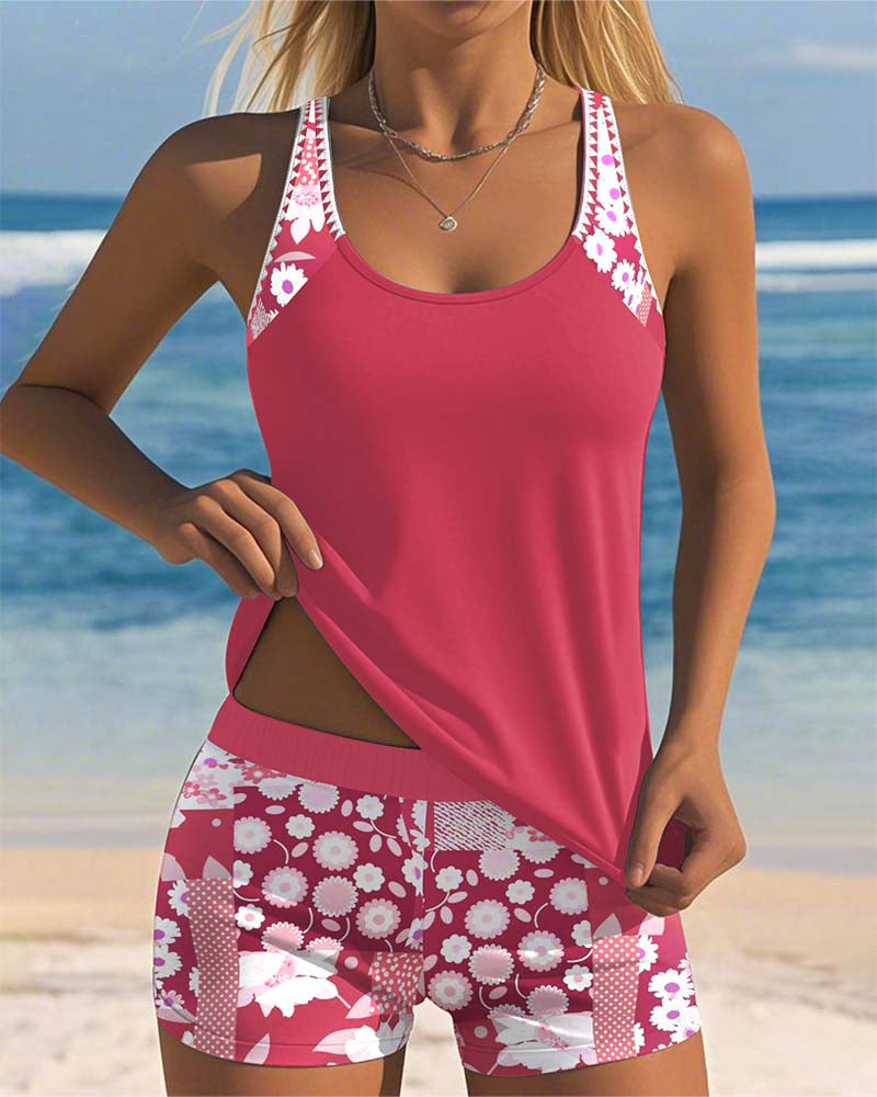 Pink/red two-piece swimwear set with patterned shorts; scoop-neck tank with contrast straps.