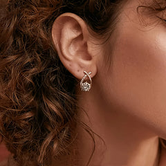 Gold luxe stud earring with crisscross design and clear stone