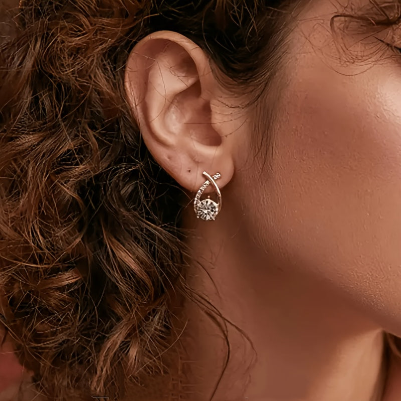 Gold luxe stud earring with crisscross design and clear stone