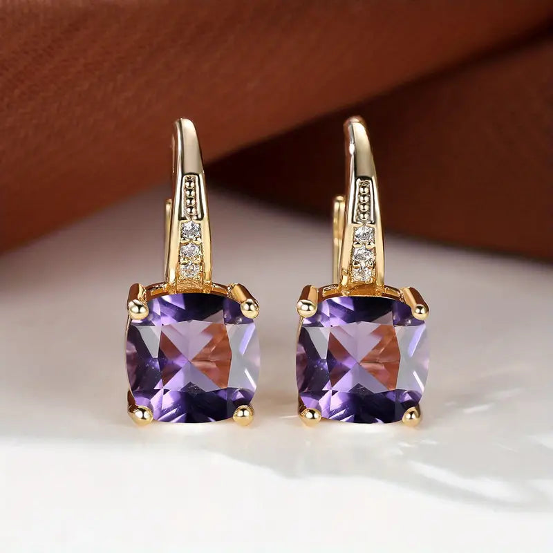 Gold hoop earrings with square purple gemstones