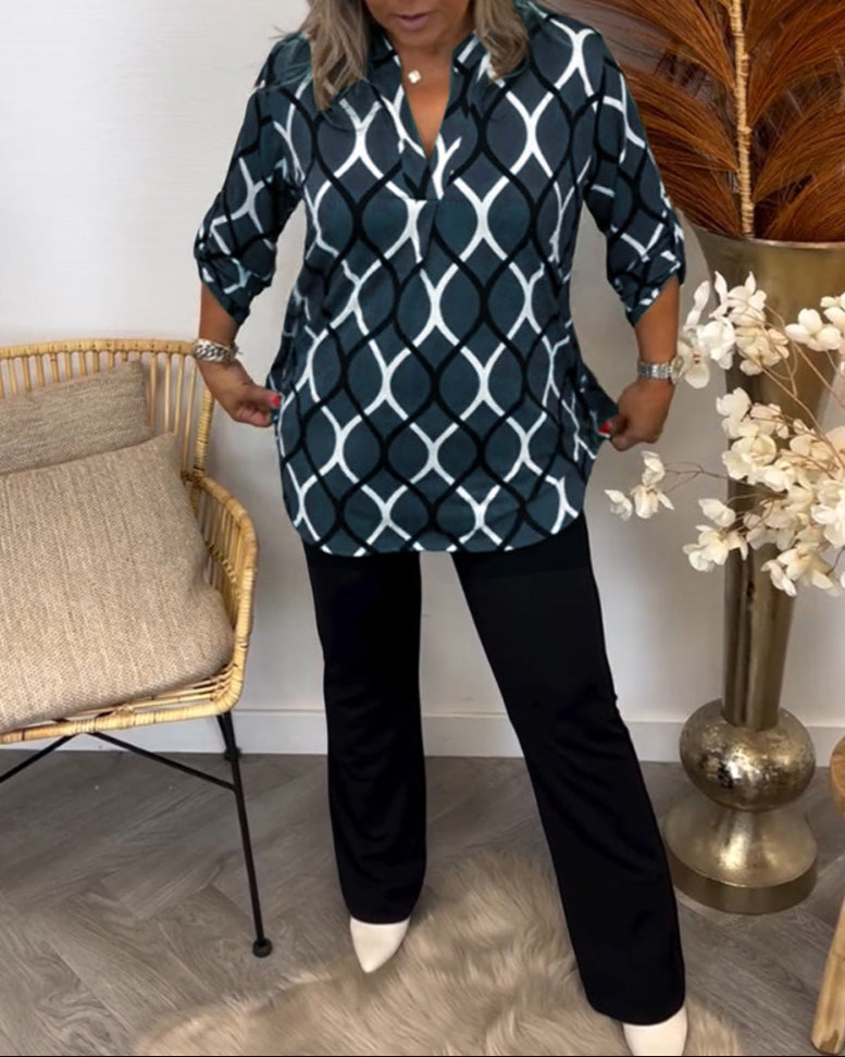 Navy long-sleeve button-up blouse with white interlocking oval pattern and curved hem