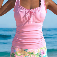 Pink tankini set with ruched scoop-neck top, drawstring bow, floral skirt